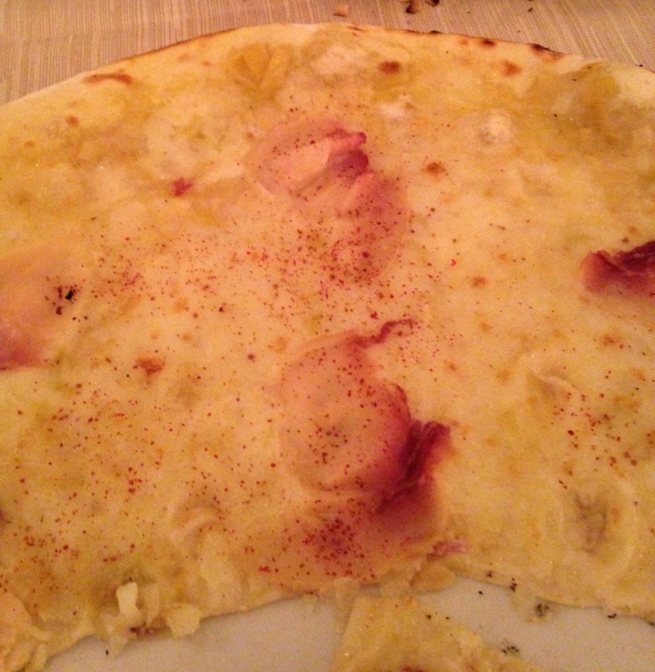Oca Bianca pizza with soft white onion, mozzarella, smoked swordfish, and a sprinkle of red pepper.