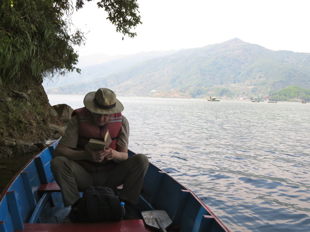 Christopher reads the river scenes from The Wind in the Willows aloud while row boating on Phewa Tal, Pokhara, Nepal. 